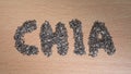 Chia word made from chia seeds on wooden plate Royalty Free Stock Photo