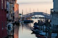 Chiaggia - Gently floating boats with scenic view of old bridge Ponte di Vigo stretching over canal Royalty Free Stock Photo