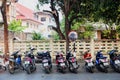 Chiang Mai, Thailand - February 9, 2020: rows of parked motorbikes on parking on street of Chiang Mai