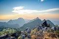 Asian Backpackers trekking waiting golden sunset sky Royalty Free Stock Photo