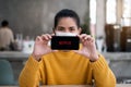 CHIANG MAI, THAILAND APR 14 2021 : Hand holding Apple iPhone with Netflix logo on a screen. Netflix is a global provider Royalty Free Stock Photo