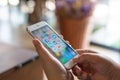 CHIANG MAI, THAILAND - Apr.27,2019: Woman holding Apple iPhone 6S Rose Gold with icons of social media on screen. Royalty Free Stock Photo