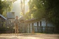 A boy playing Gong Keng is a Thai traditional toy that uses bamboo to make two legs to walk