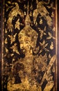 Chiang Mai, Thailand. JAN 10, 2023 : Thai angel golden painting on wooden gate in Buddhist temple