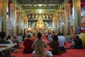 Devotees and monks inside a Buddhist temple Royalty Free Stock Photo