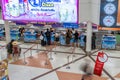 Tourists and travellers wait in line to check in at Chiang Mai International Airport check in counters