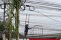 CHIANG-MAI, THAILAND. 15 JUNE 2023 : Technician cutting cable and Electricians are dismantling the wiring from the building.