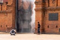 Tourists are taking photos at Thapae Gate with water spray.