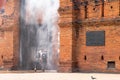 Tourists are walking through water spray installed at Thapae Gate.