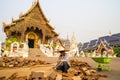 Chiang Mai/Thailand - March 16, 2019: Worker is paving the walkway with cobblestones in a Buddhist temple.