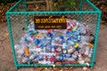 Chiang Mai/ Thailand, May 9, 2019: Recycled trash bin made of wire mesh filled with clear plastic bottles and aluminum cans.