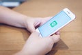 CHIANG MAI, THAILAND - May.10,2019: Woman holding Apple iPhone 6S Rose Gold with LINE apps on screen on wooden table. Royalty Free Stock Photo