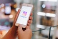 CHIANG MAI, THAILAND - May.10,2019: Woman holding iPhone with Instagram application on the screen at shopping mall. Royalty Free Stock Photo