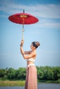 Chiang Mai, Thailand-May 13,2018: Young Asian Woman wearing Lanna traditional style costume with red umbrella in Chiang Mai, Royalty Free Stock Photo