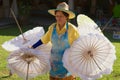 Thai women carries traditional bamboo umbrellas at the factory in Chiang Mai, Thailand.