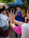 Chiang Mai, Thailand - October 25, 2020: Hands of Northern Thai traditional dancer in Lanna traditional dress with long finger