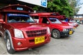 Iconic traditional red truck taxis parked and waiting for the passenger at Arcade bus station in Chiang Mai, Thailand