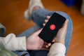 Close-up image of a female holding an iPhone14 with a Youtube music logo on screen