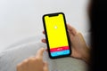 CHIANG MAI, THAILAND, Sep 06, 2023 : Snapchat application icon on Apple iPhone X smartphone screen close-up in woman