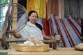 woman spinning cotton into thread with traditional wheel Royalty Free Stock Photo