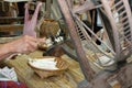 woman spinning cotton into thread with traditional wheel Royalty Free Stock Photo