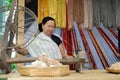 woman spinning cotton into thread with traditional wheel Royalty Free Stock Photo