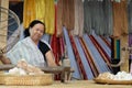 woman spinning cotton into thread with traditional wheel Royalty Free Stock Photo