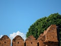 Chiang Mai, Thailand, Southeast Asia - Blue clear sky with green leafy tree and brick fortress wall Royalty Free Stock Photo