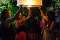 Young female tourists release a floating lantern in Chiang Mai,