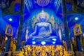 CHIANG RAI, THAILAND - FEBRUARY 01, 2018: Beautiful indoor view of huge buddha statue sitting in the bluew temple at Wat