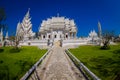 CHIANG RAI, THAILAND - FEBRUARY 01, 2018: Outdoor view of stoned path with a gorgeous ornate of white temple located in