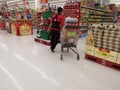 CHIANG RAI, THAILAND - FEBRUARY 15 : Unidentified male worker taking soft drink soda on shopping cart in supermarket on February