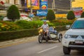 CHIANG RAI, THAILAND - FEBRUARY 01, 2018: Unidentified man using a helmet protection and riding a tricycle is the most