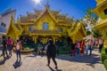 CHIANG RAI, THAILAND - FEBRUARY 01, 2018: Unidentified people around of Golden house at the Wat Rong Khun in Chiang Rai