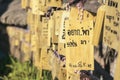Chiang Rai, Thailand - January, 11, 2022 : Many small signs or plaques called wooden tags carrying written visitor messages and