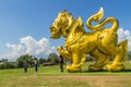 Golden lion statue logo under blue sky and white clouds background at Boonrod farm or singha park, the famous agriculture tourist Royalty Free Stock Photo