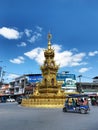 CHIANG RAI, THAILAND-November 9, 2020: A tuk-tuk is passing by Chiang Rai clock tower