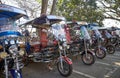 Chiang Saen, Chiang Rai Province, Thailand - February 19, 2019: Traditional Thai auto rickshaws tuk-tuk of different colors stan Royalty Free Stock Photo