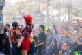 Closeup crowd of Thai and tourists have fun playing by water at the Songkran festival.