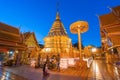 CHIANGMAI,THAILAND-NOVEMBER 1,2020:Thai woman wearing a Thai Lana dress sits and prays at Wat Phra That Doi Suthep