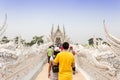 CHIANGRAI, THAILAND - APRIL 12: Unidentified travelers visit Wat Rong Khun a famous white temple at northen thailand on December