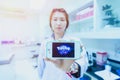 Chiangrai, Thailand - August 16th, 2016 : Asia woman medical technician holding a smart phone and show Pokemon Go logo in