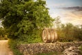 Chianti region, wine barrel over a stone wall, on the vineyard road. Radda in Chianti, Tuscany, Italy Royalty Free Stock Photo