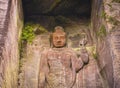 Close-up on the Hyaku-shaku kannon buddha carved in Mount Nokogiri stone quarry. Royalty Free Stock Photo