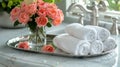 chic bathroom decor: silver tray with towels and roses on marble vanity in elegant setting on neutral background