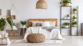 Chic Bedroom Retreat, Bright Interior with Patterned Pouf and Basket Accents Royalty Free Stock Photo