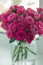 A chic bouquet of small pink roses in a jar on the windowsill. Cute still life