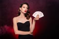 Chic classy lady poker player lucky winning rich wealth with hearts playing cards combination over dark background