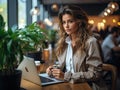 Blogger working at trendy cafe coffee in hand