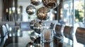 A chic dining room featuring a modern glass table surrounded by metallic dining chairs and a row of metallic globe Royalty Free Stock Photo